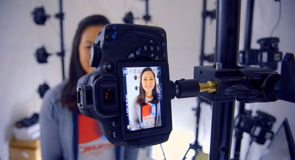 "On the Whiteboard" host Pamela Woon prepares to get a 3D model of her face, as part of a process that gathers data on voices, body gestures and facial expressions to continuously improve the Kinect experience.