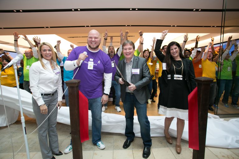 Store Manager Jared Harris and Greg Johnston, GM of retail stores, cut the ribbon to open the company’s newest store at Woodland Hills Mall in Tulsa, Okla., on Thursday, Nov. 20, 2014.