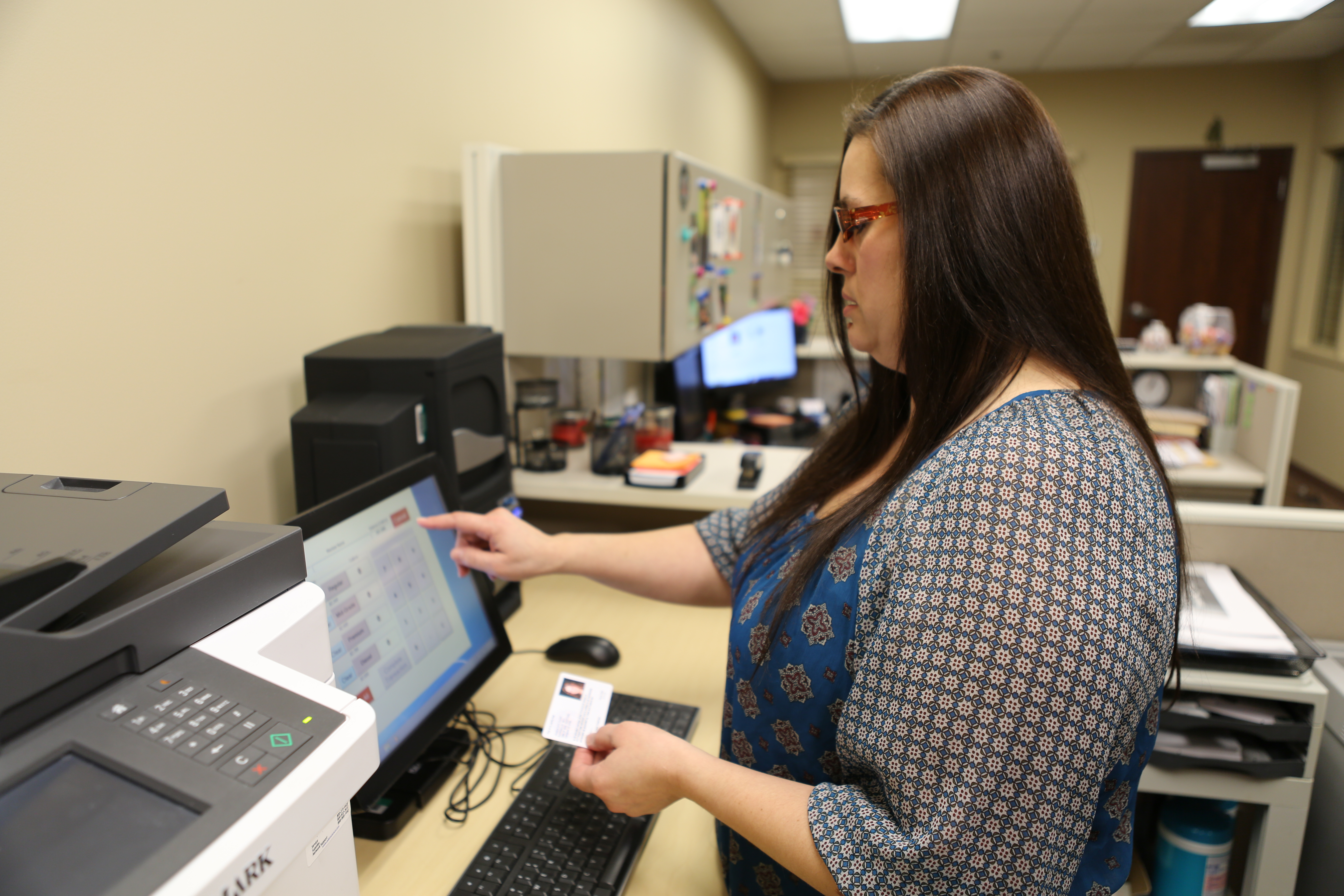 Pokagon Enrollment Coordinator Beth Edelberg enters information from a tribal citizen’s ID badge into the new system.