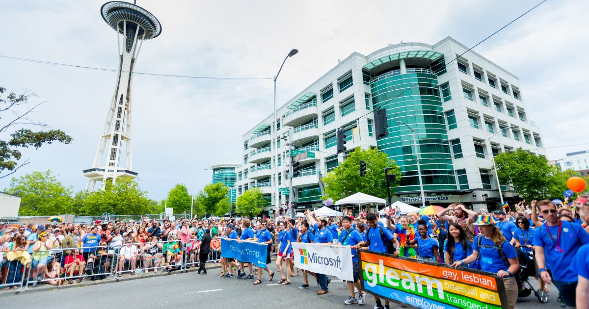 Microsoft employees, partners, family and friends pass the Space Needle holding banners for Microsoft and GLEAM, Microsoft’s LGBT Employee Resource Group.