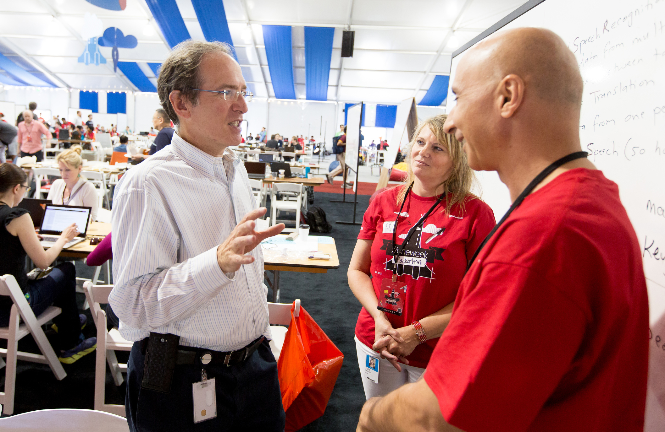 Scott Charney, left, corporate vice president of Trustworthy Computing; Paige Williams, director of global readiness for Microsoft; and Osama Shabaneh, Skype International principal group manager, work on a hack project to benefit Translators Without Borders. (Photography by Scott Eklund/Red Box Pictures)
