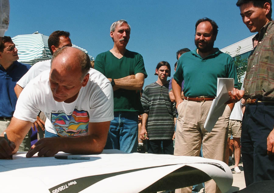 Dave Cutler signs autographs at a Windows NT ship party.