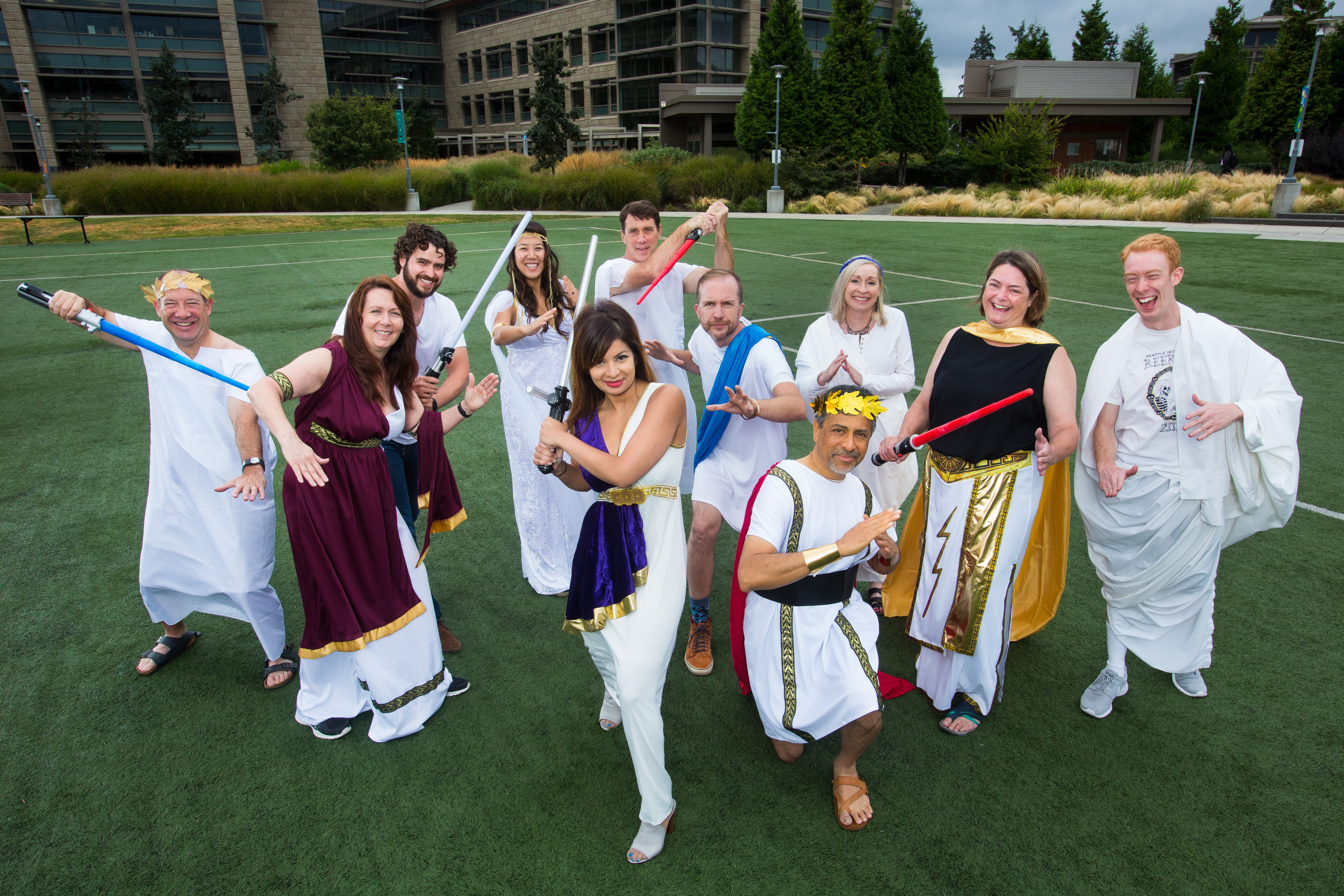 The Windows Insider Community team has fun with togas and lightsabers. The team includes (from left) Joe Camp, Cheryl Sanders, Blair Glennon, Tyler Ahn, Dona Sarkar, Derek Haynes, Thomas Trembly, Manik Rane (kneeling), Ursula Hildenbrand, Joan Steelquist and Seth Rubinstein. (Photo by Dan DeLong).