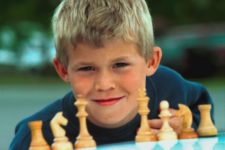 Magnus Carlsen as a child playing chess.