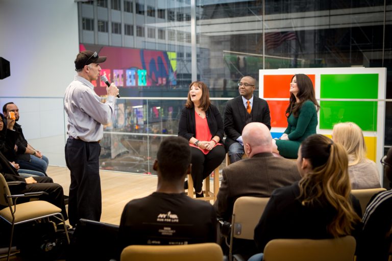People are interviewed on a stage