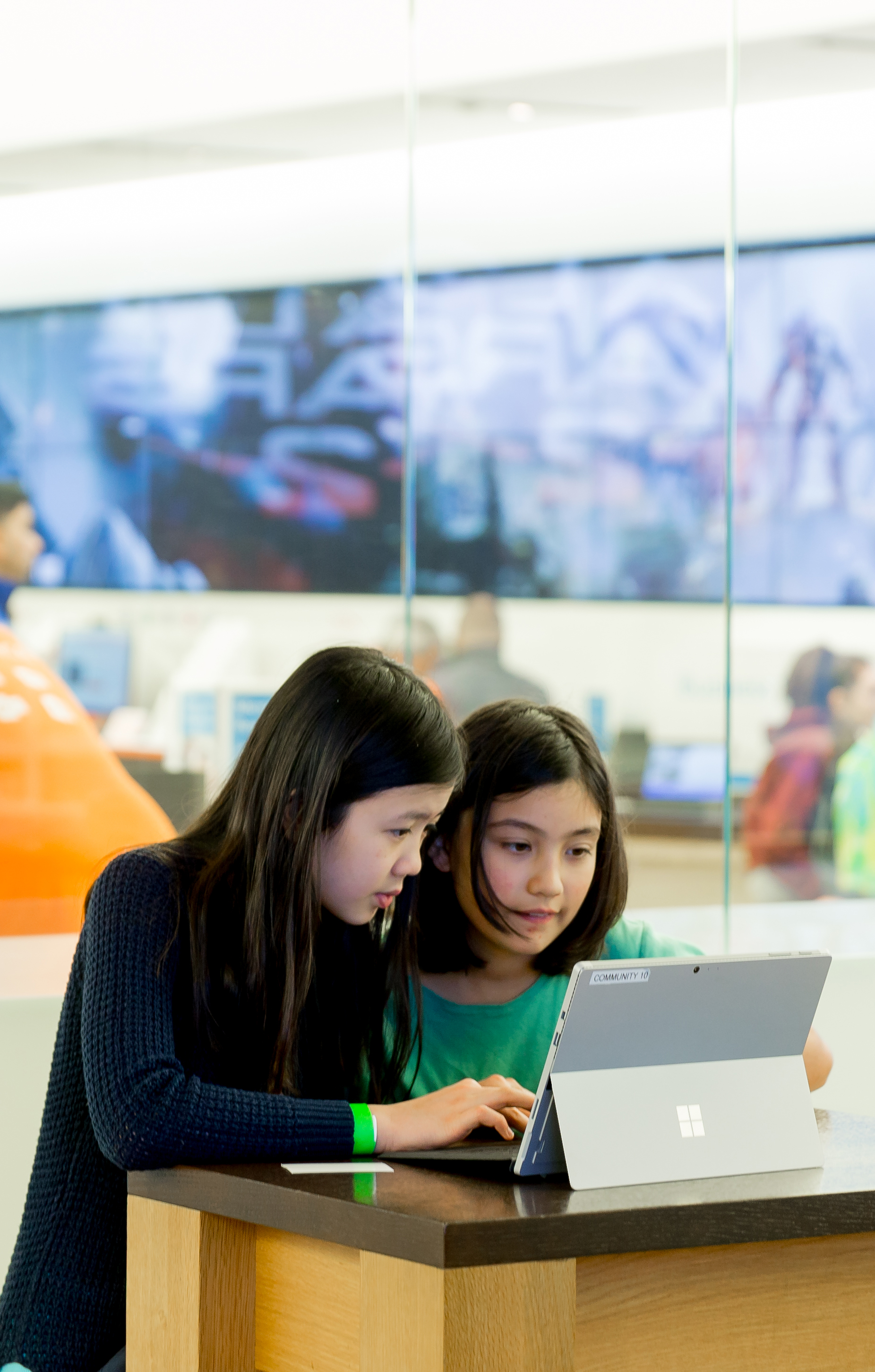 Photo of two girls looking at a computer together