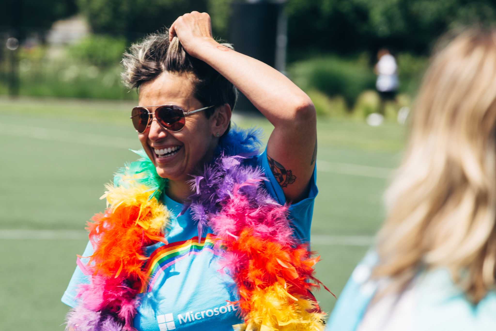 Photo of person wearing rainbow-colored feather boa.