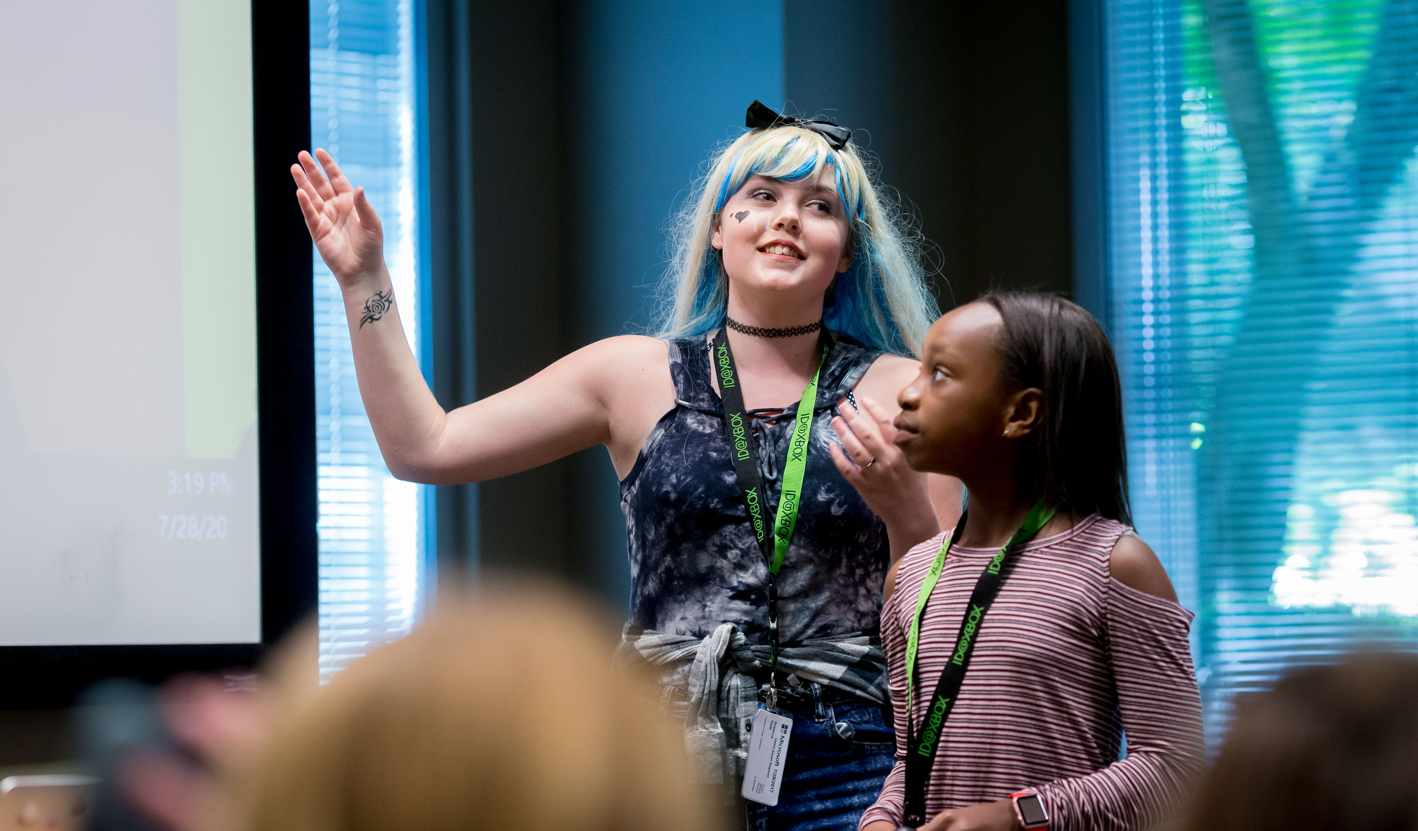Two girls at Girls Make Games camp present the video game they created