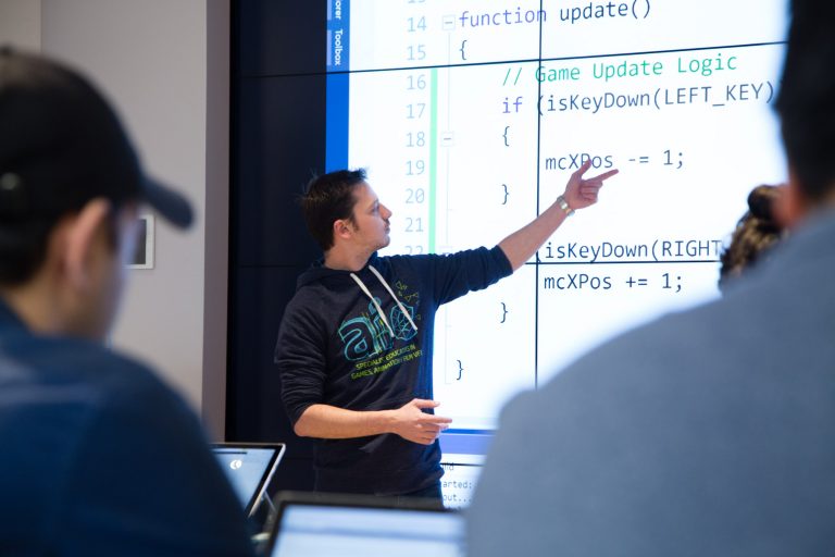 A man points at text on a large screen