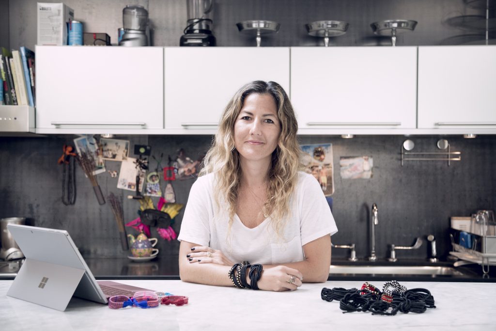 Ariela Suster surrounded by her corded bracelets