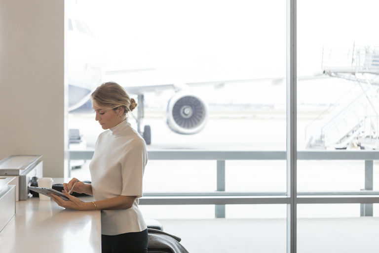 A woman uses a Surface tablet in an airport