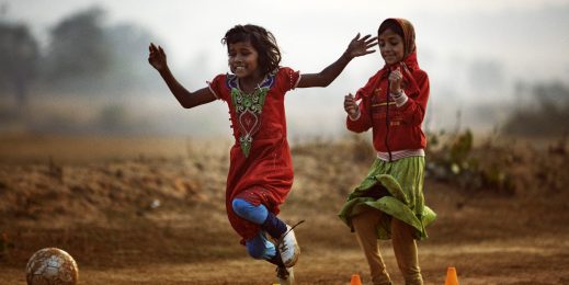 Young girls play soccer