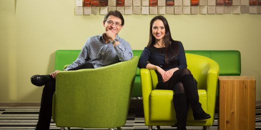 Jordi Ribas and Kristina Behr sit in green chairs, smiling at camera