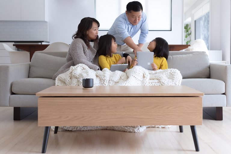 A family uses Surface Pro Go in a living room