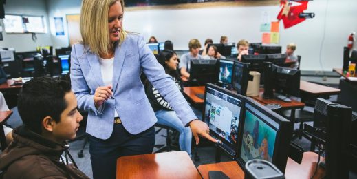 A teacher helps a student