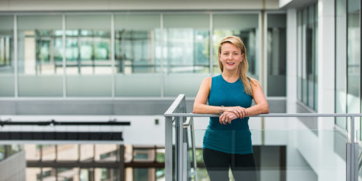 Portrait of Angela Mills in an office building with natural light and many windows