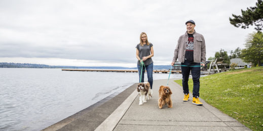Craig and Melissa Cincotta walk their two dogs near a large lake
