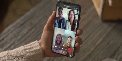 Hand holding a phone displaying a Teams meeting