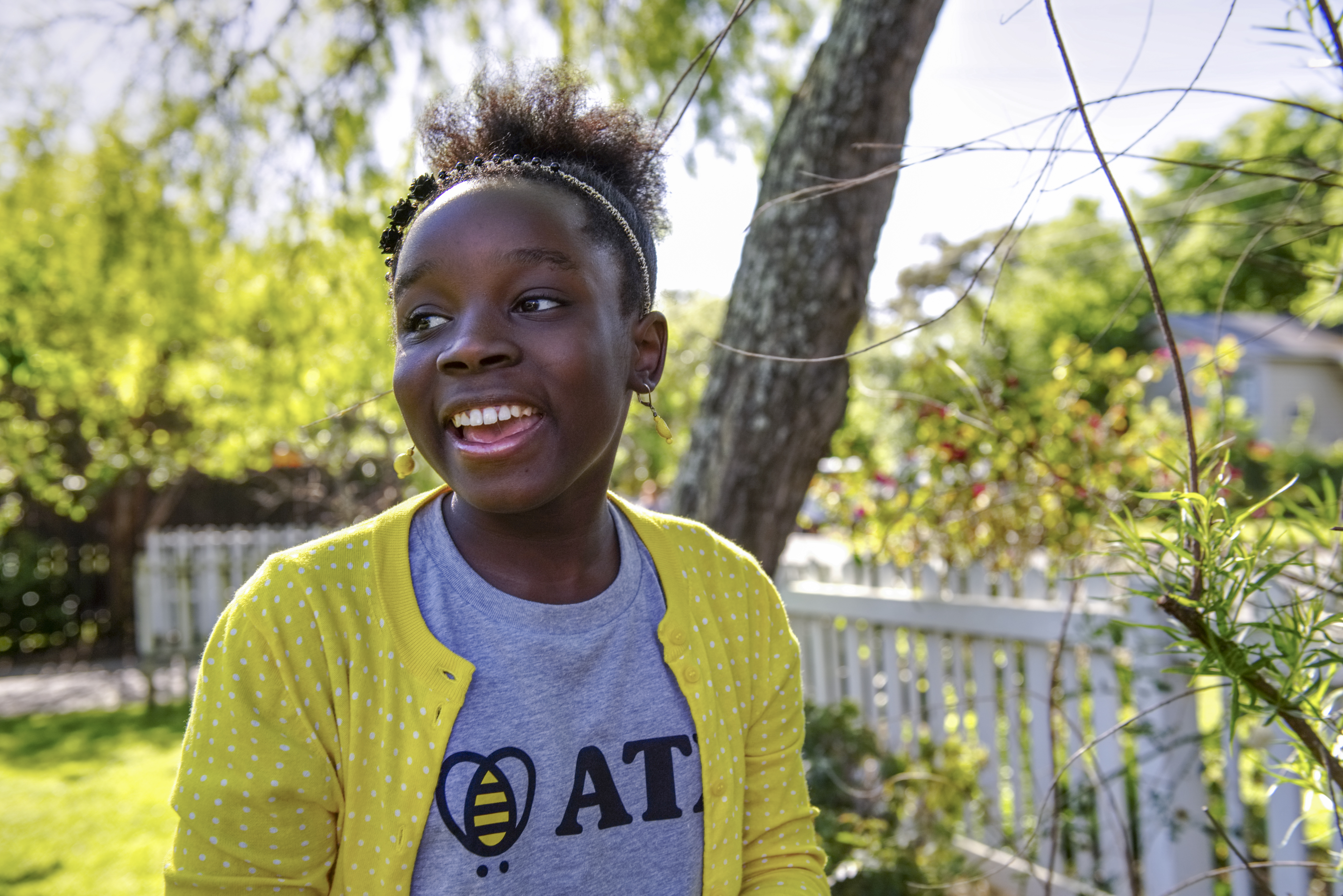 Photo of smiling young girl outdoors.