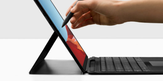 A hand using a pen on a Surface Pro X
