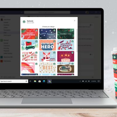 Starbucks app on a laptop sitting next to a Starbucks cup