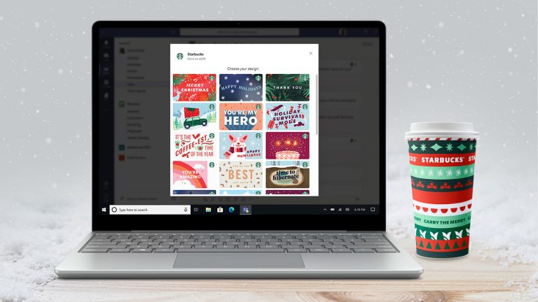 Starbucks app on a laptop sitting next to a Starbucks cup