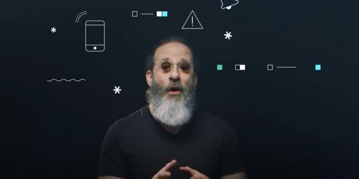 Man speaking in front of a background of icons