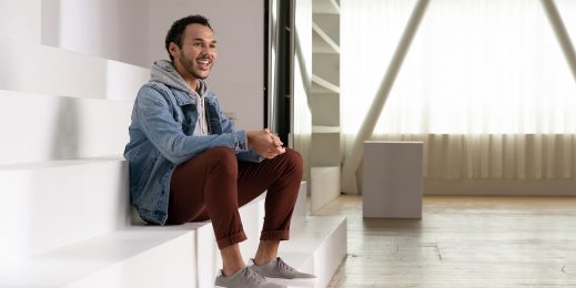 Smiling man sitting on large stairs