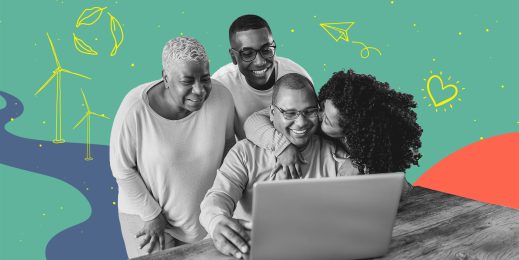 Smiling family gathered around a computer