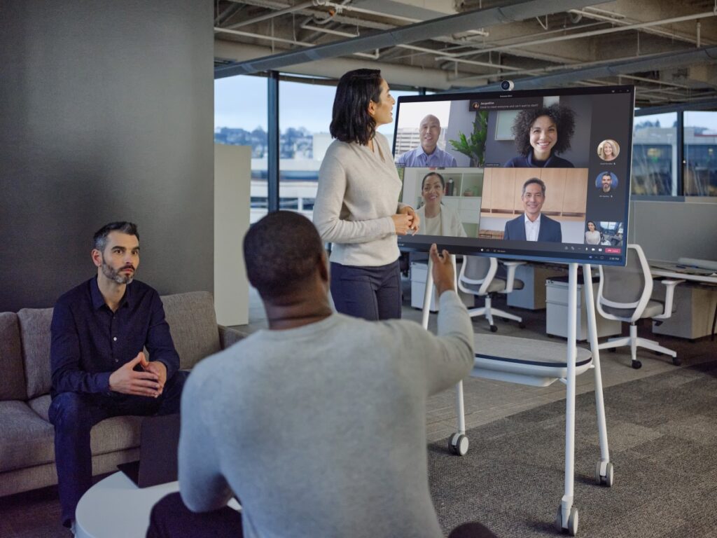 Profesionales participando en una reunión híbrida con Microsoft Teams