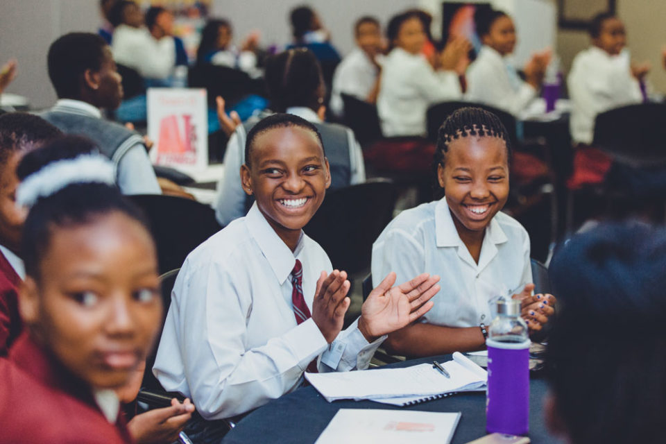 High school girls smiling and clapping hands