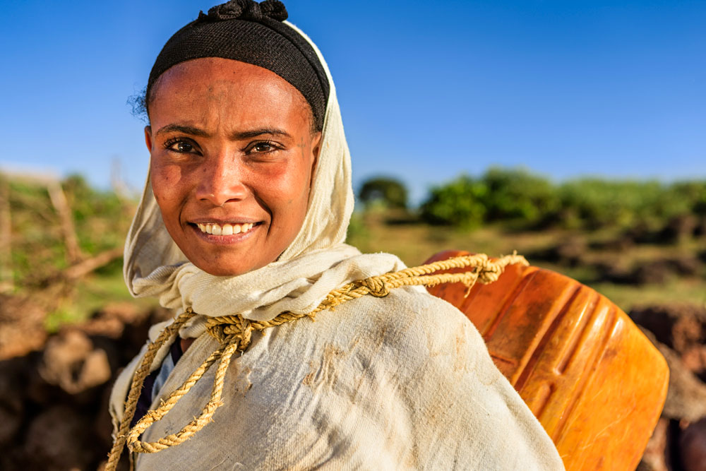 African woman carrying water