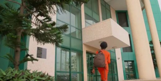 women wearing Orange dress and walking into a building