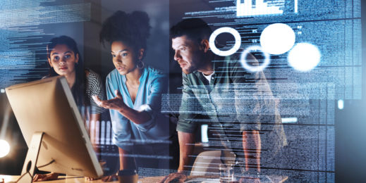 A diverse team of digital specialists working together on a coding solution.