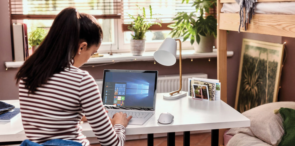 Young female student works from home using Microsoft technology.