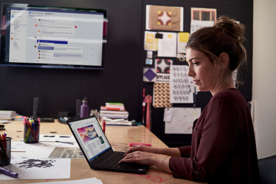 Woman working at her laptop in a boardroom