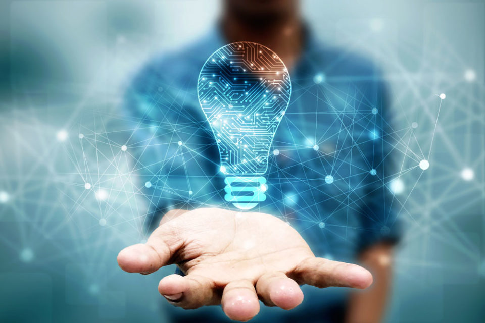 Outstretched hand holding a light bulb