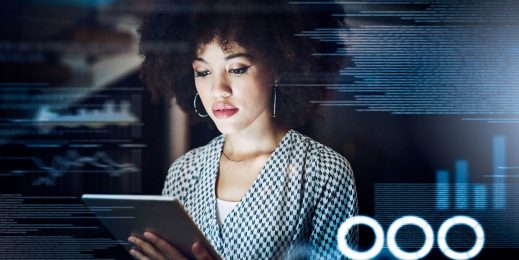 Businesswoman immerses herself in company data that she accesses through her tablet