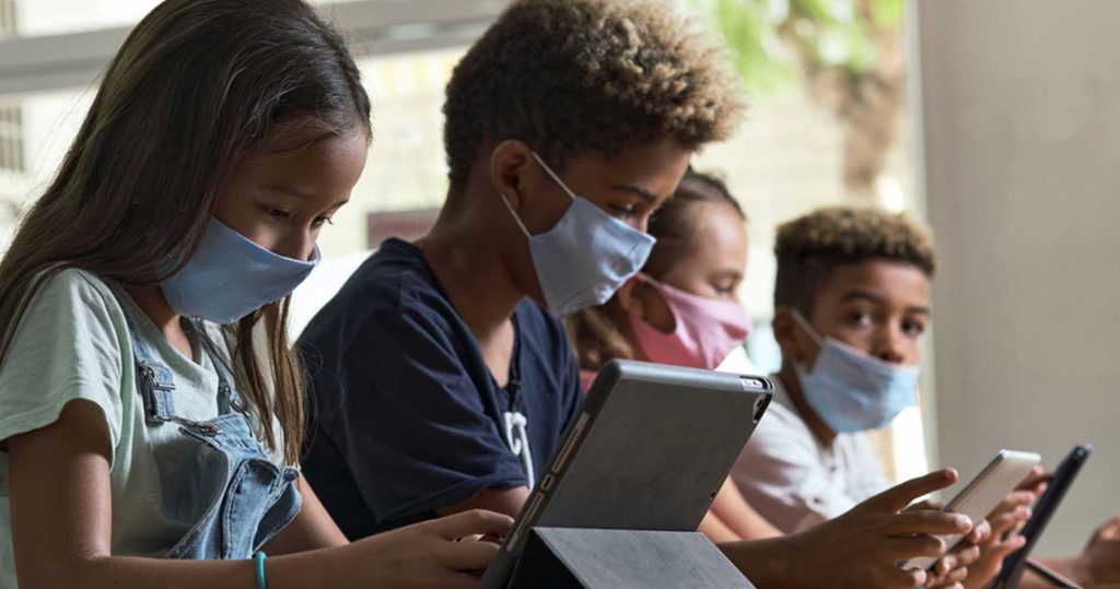 A school class using technology to learn during the pandemic.