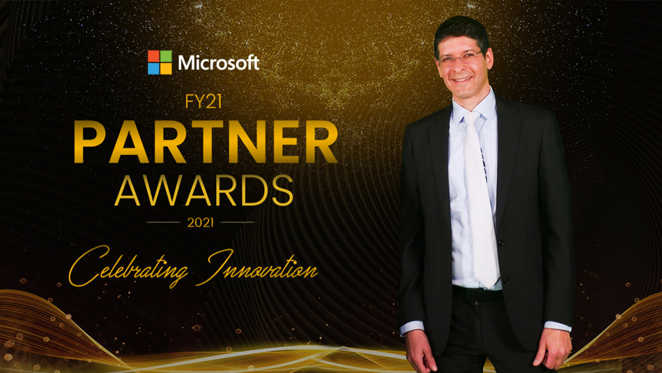 lionel moyal standing next to microsoft partner awards logo