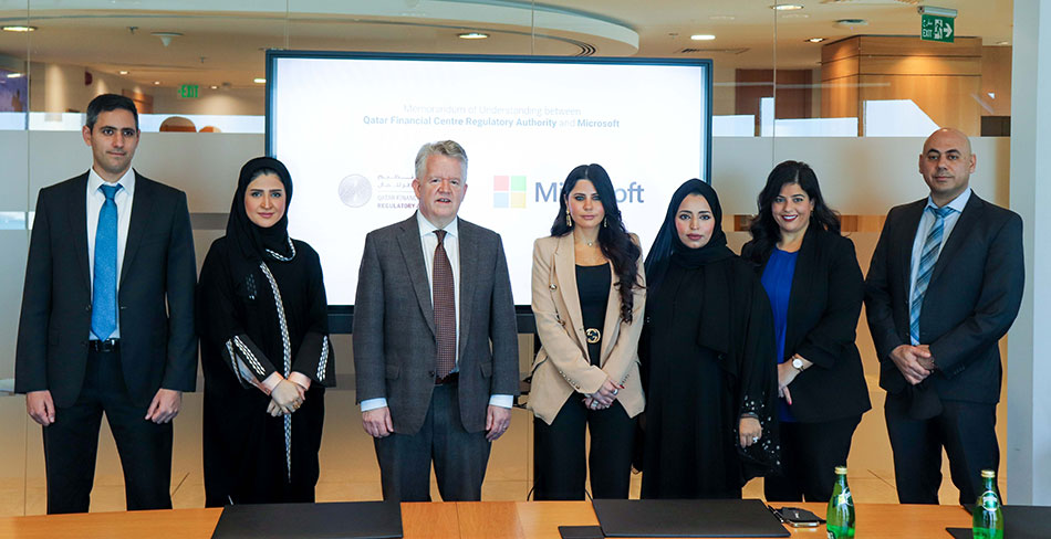 Microsoft and QFCRA teams during the signing ceremony.