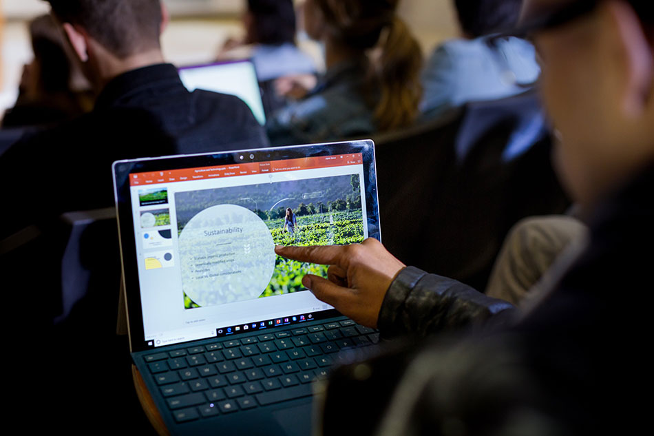 A man reading Microsoft's sustainability messaging from his device