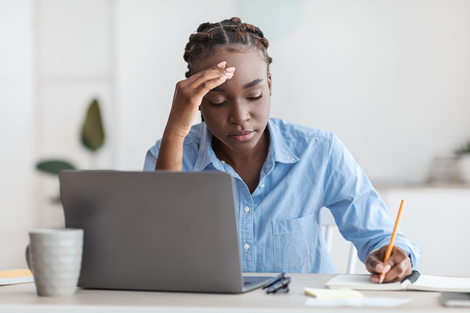 Tired young woman works from home