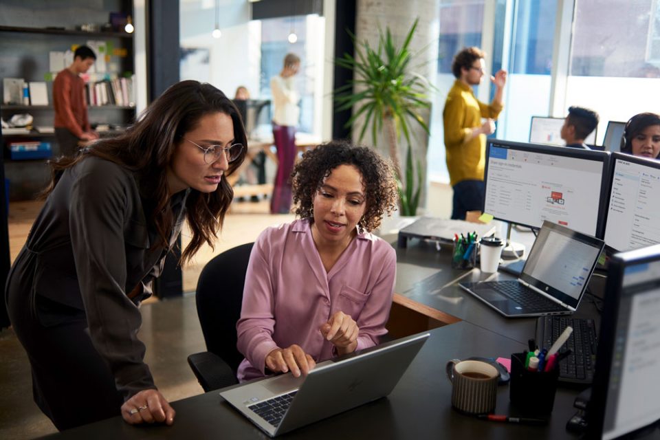 SME office with two women looking at laptop