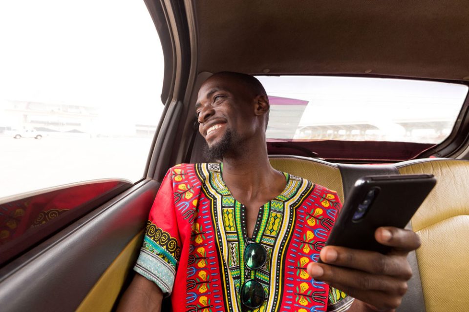 Man using a cellular device while seated in a car