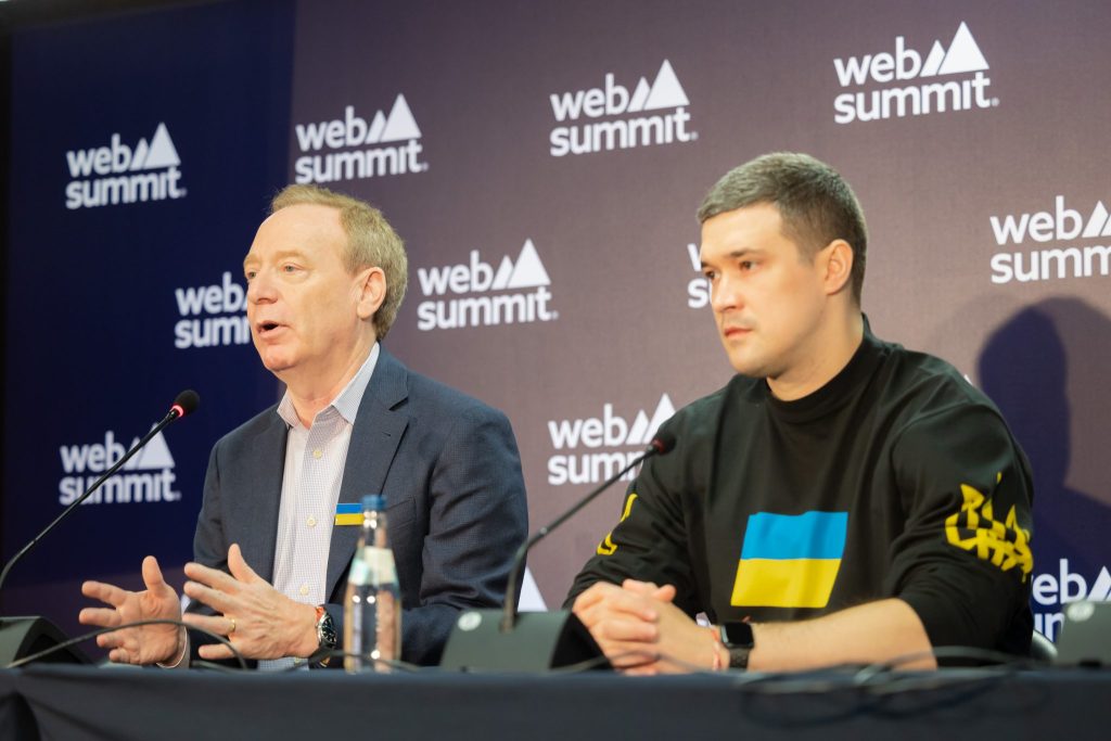 two men speaking at conference