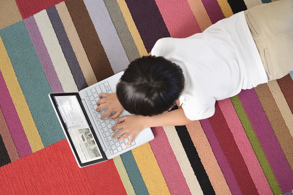 kid studying on laptop