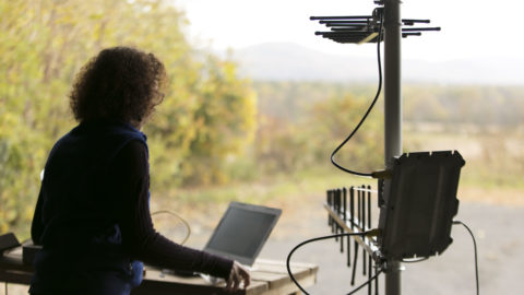 Woman using computer in rural area
