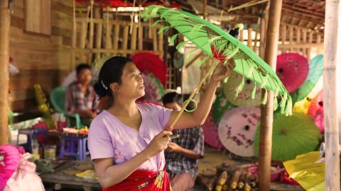 Thin Thin Kine examines one of the umbrellas made in her factory in Myanmar. She is among those worldwide who have benefitted from the growth of cloud-based banking in emerging and developing markets, where traditional banking services are not available.