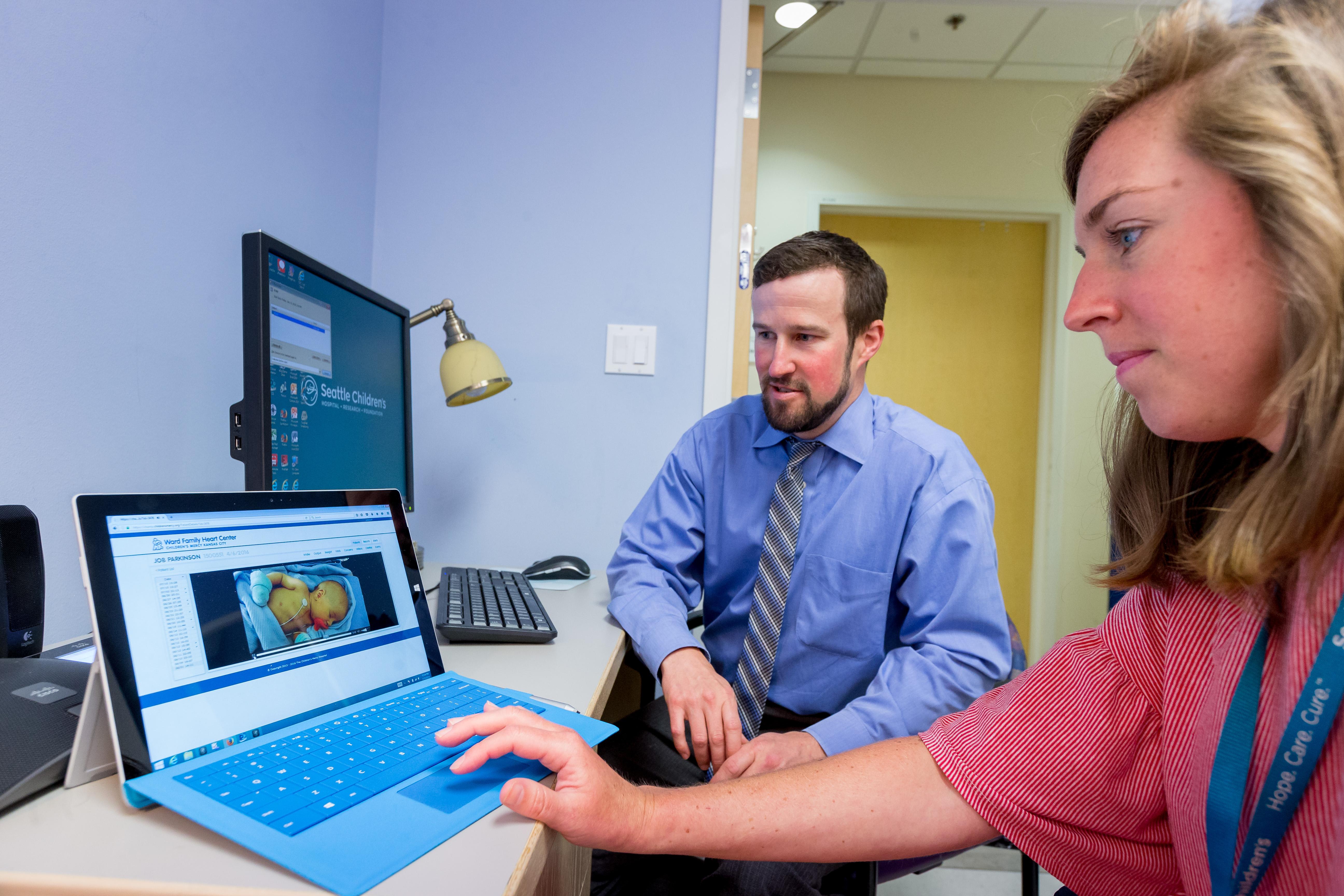 Dr. Matthew Files and nurse Kendra Waldburger monitor baby Job remotely at Seattle Children’s Hospital. (Photography by Scott Eklund/Red Box Pictures)